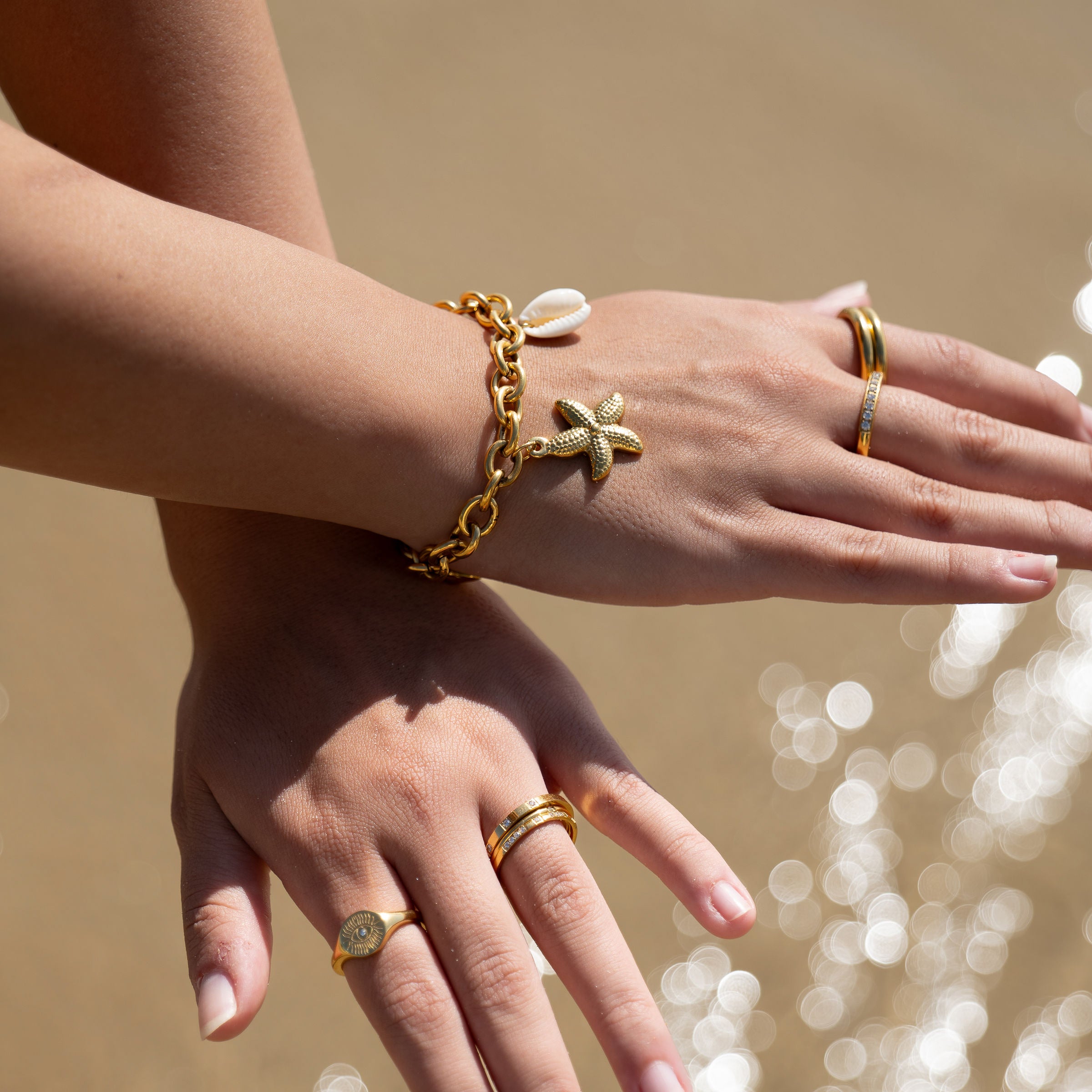 Sunseer Ring lifestyle beach shot — Maevi Jewellery
