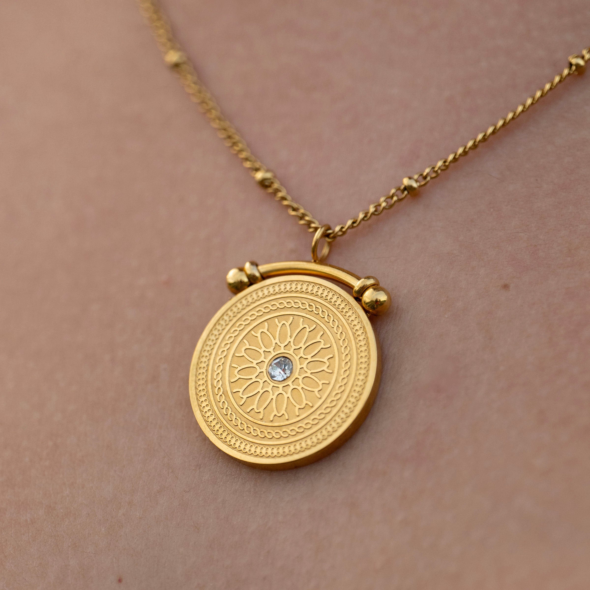 Round gold coin necklace with intricate detailing, tarnish-free everyday jewellery close-up