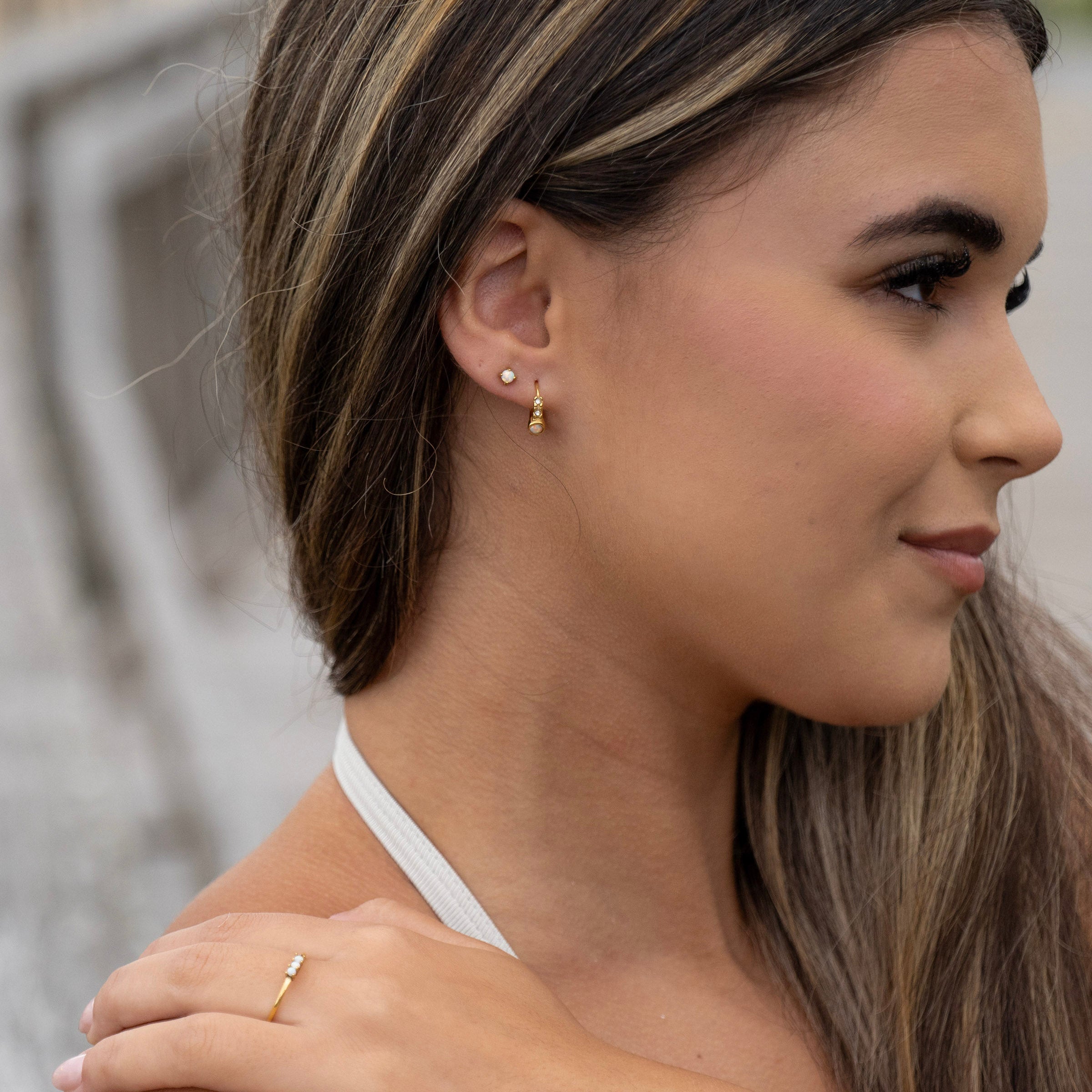 Gold opal earring pair and matching ring close up