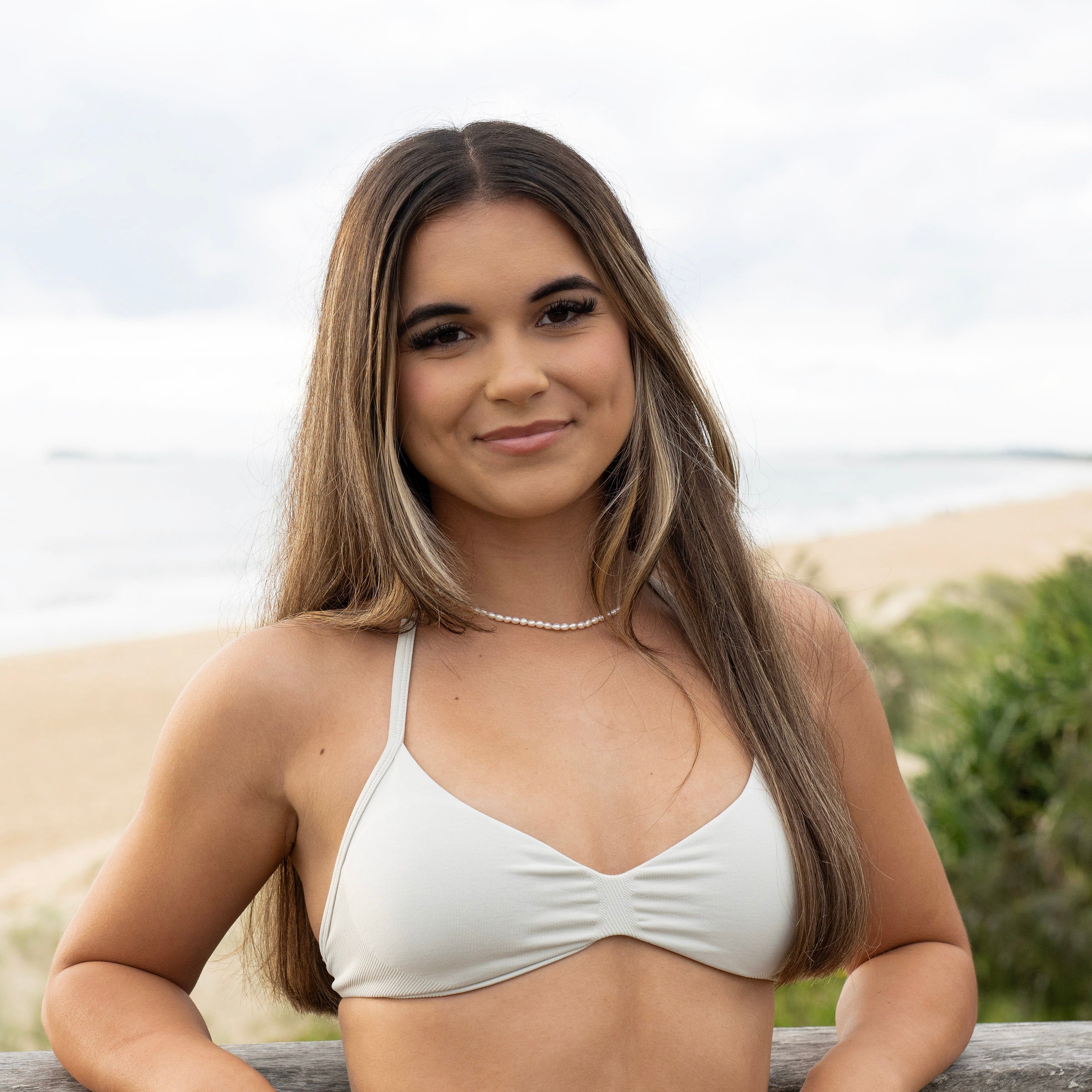 Short pearl necklace sitting high on the neckline