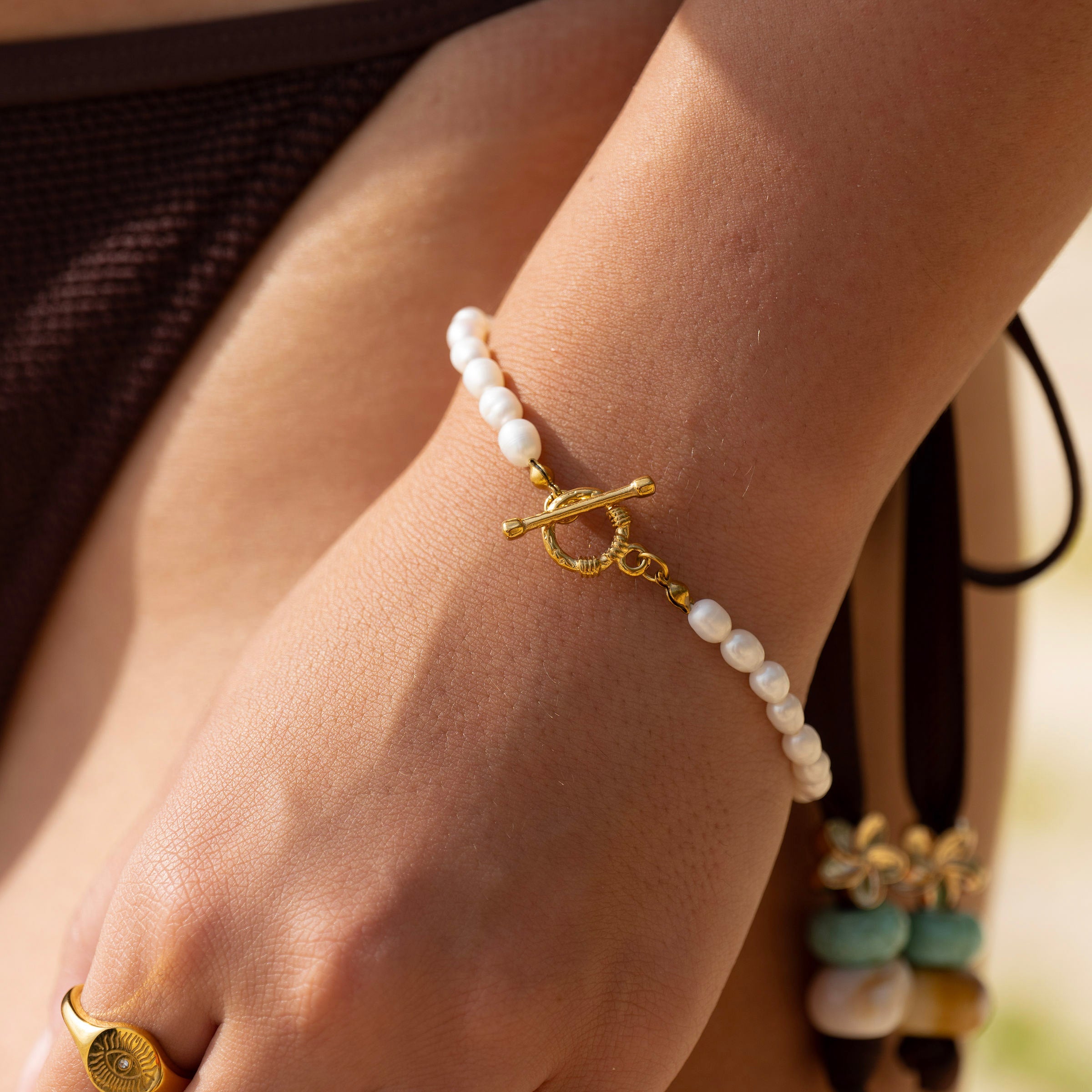 Gold and pearl bracelet with toggle clasp in 18K PVD stainless steel, waterproof tarnish-free jewellery worn on wrist