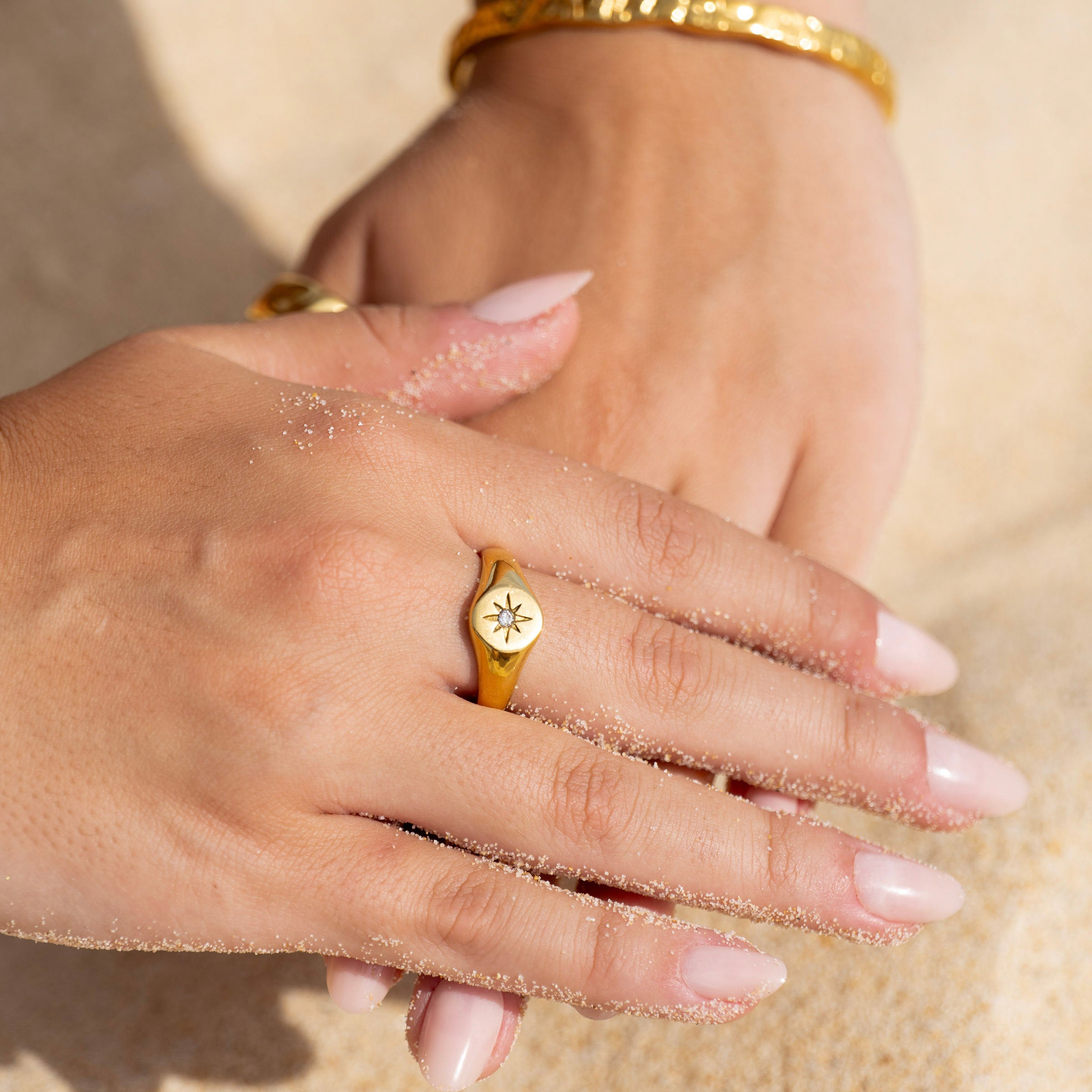 Ocean-inspired gold signet ring with star motif, beach lifestyle jewellery close-up