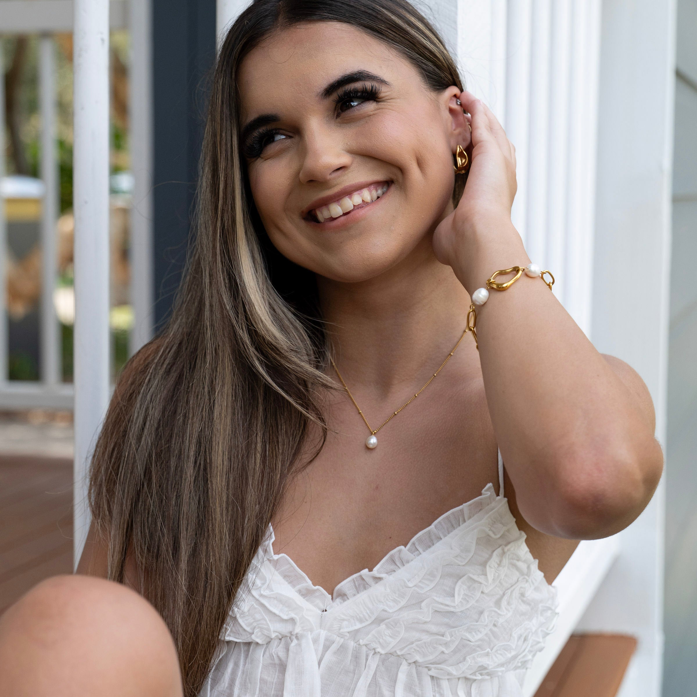 Elegant gold pearl necklace, waterproof stainless steel jewellery styled on neckline with summer outfit