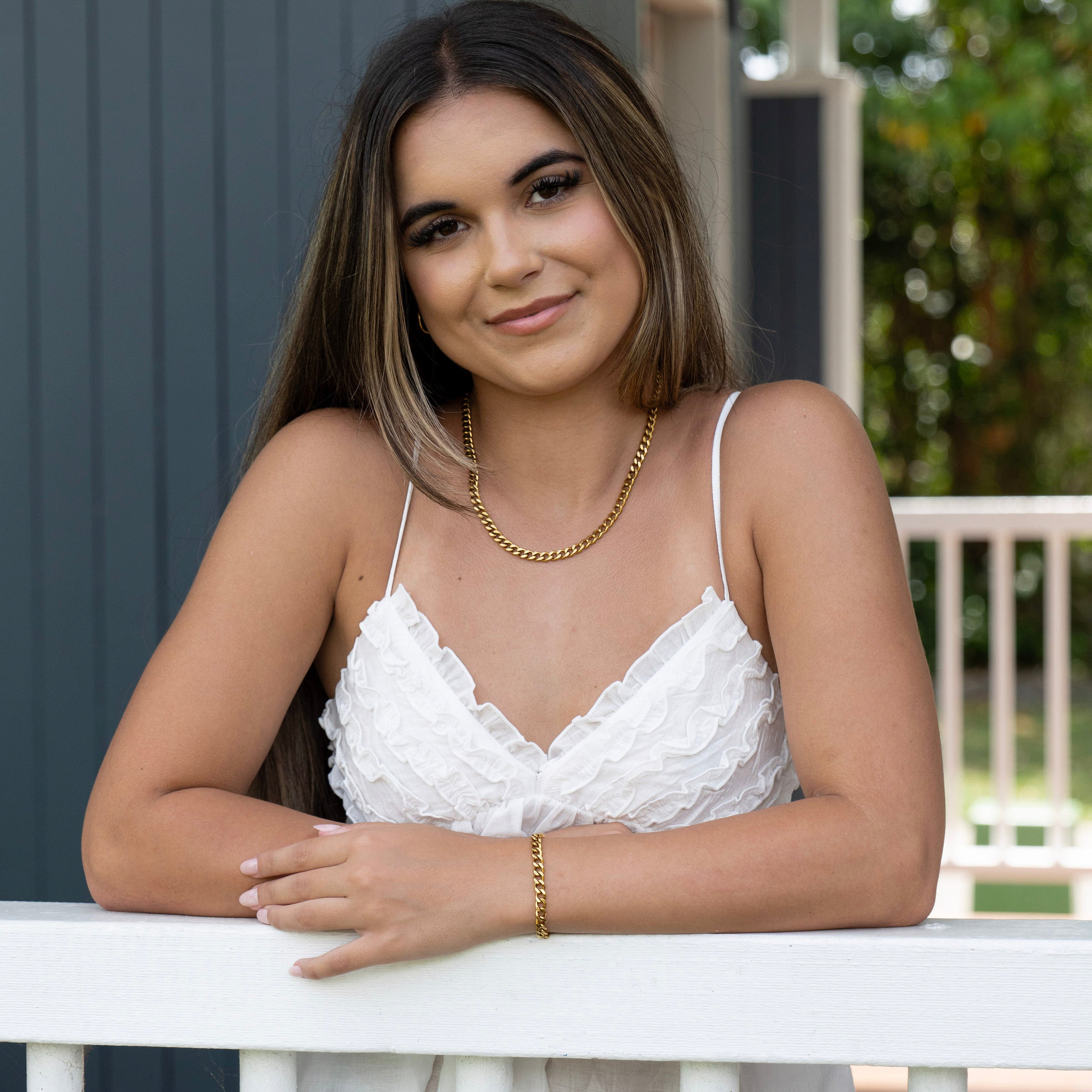 Gold curb chain necklace and bracelet bundle worn on model