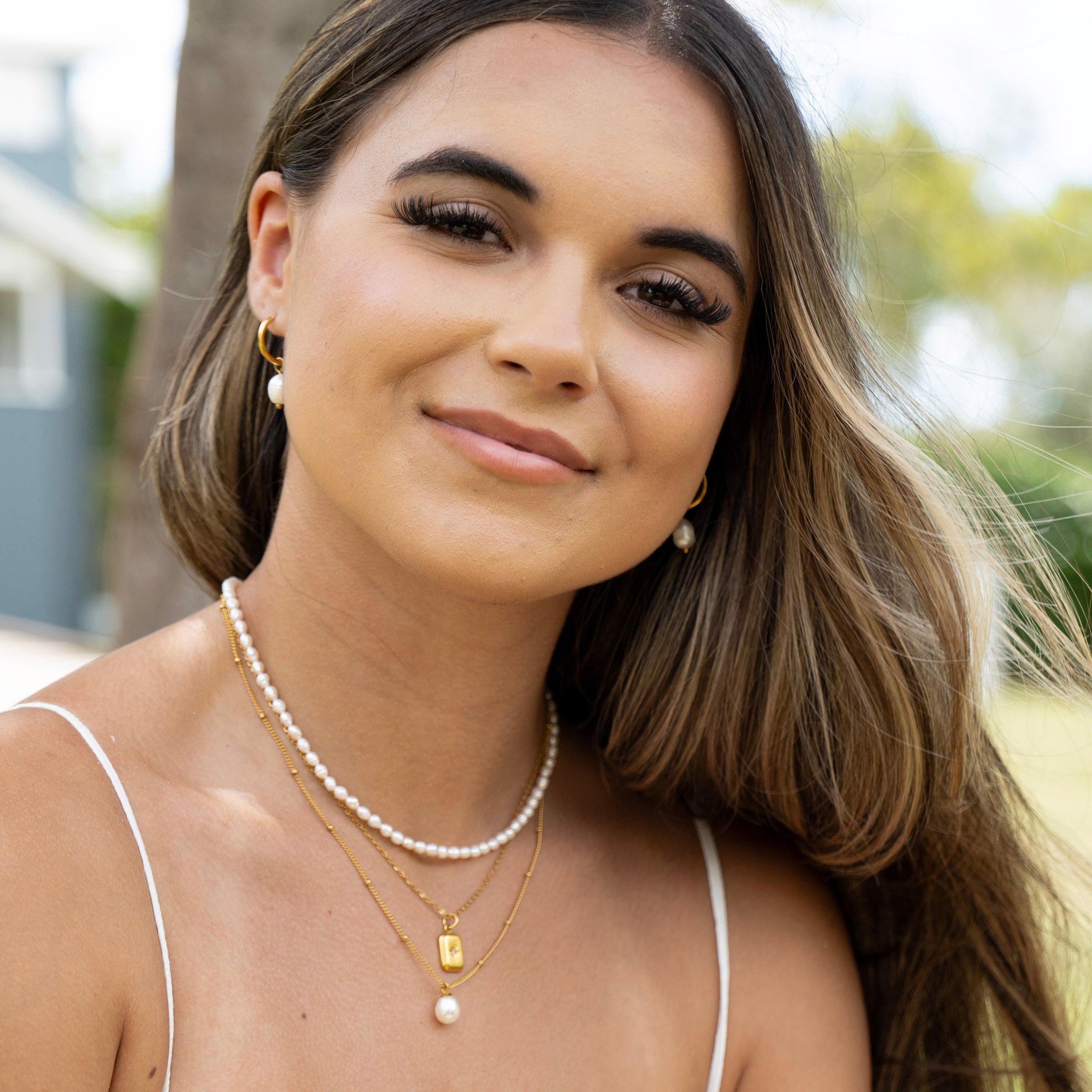 Pearl choker and gold pendant necklace stack