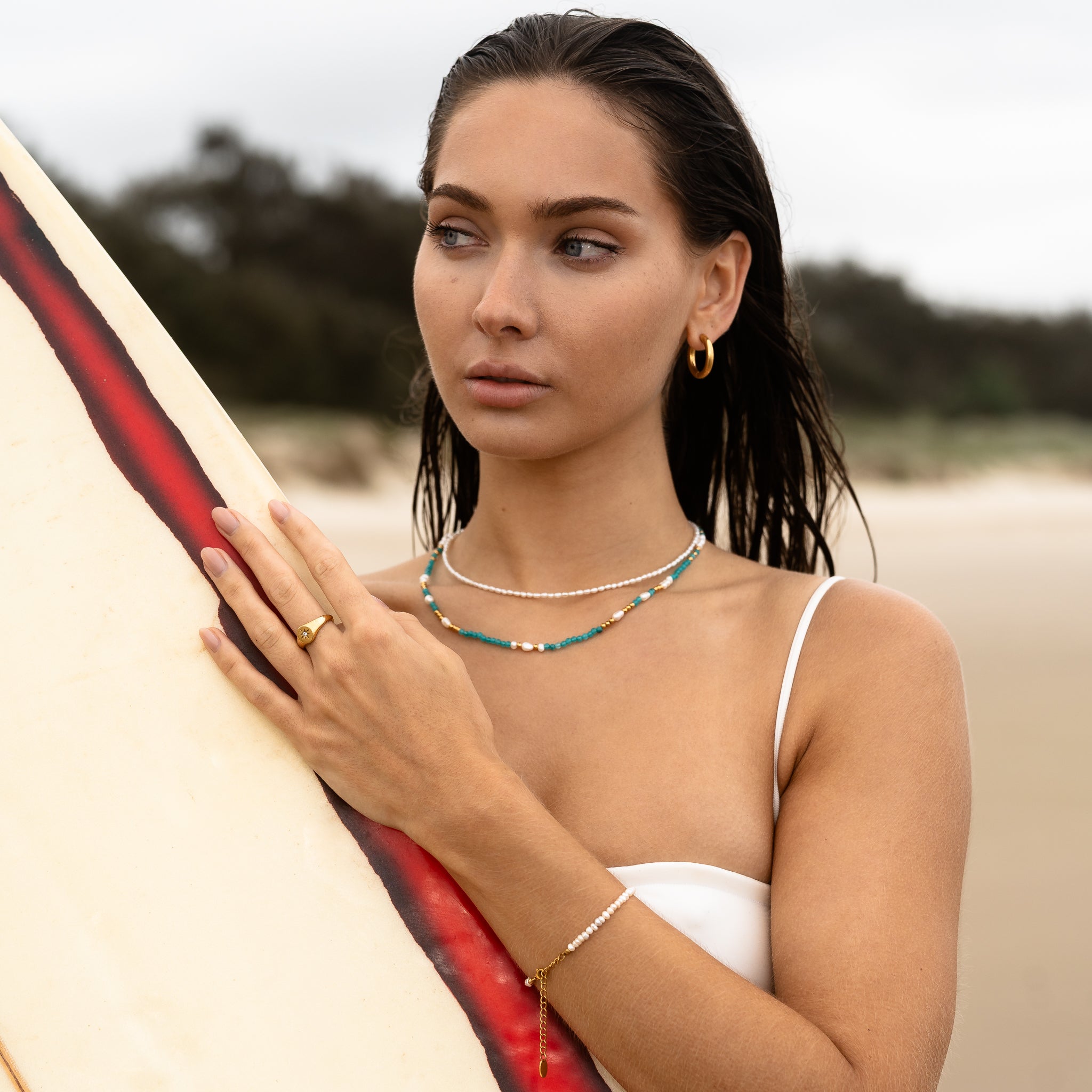 Gold and turquoise beaded necklace stack with freshwater pearl choker