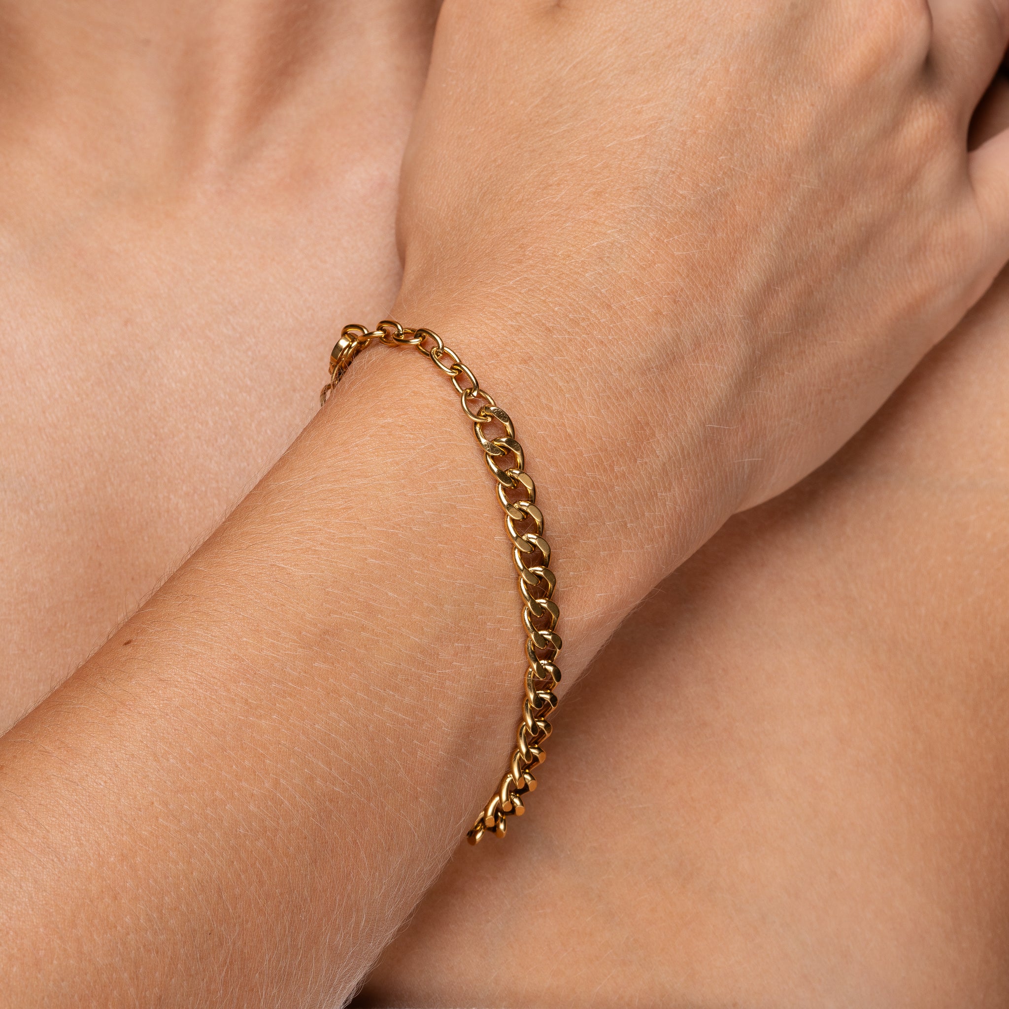 Woman wearing Tethys gold curb bracelet – Maevi