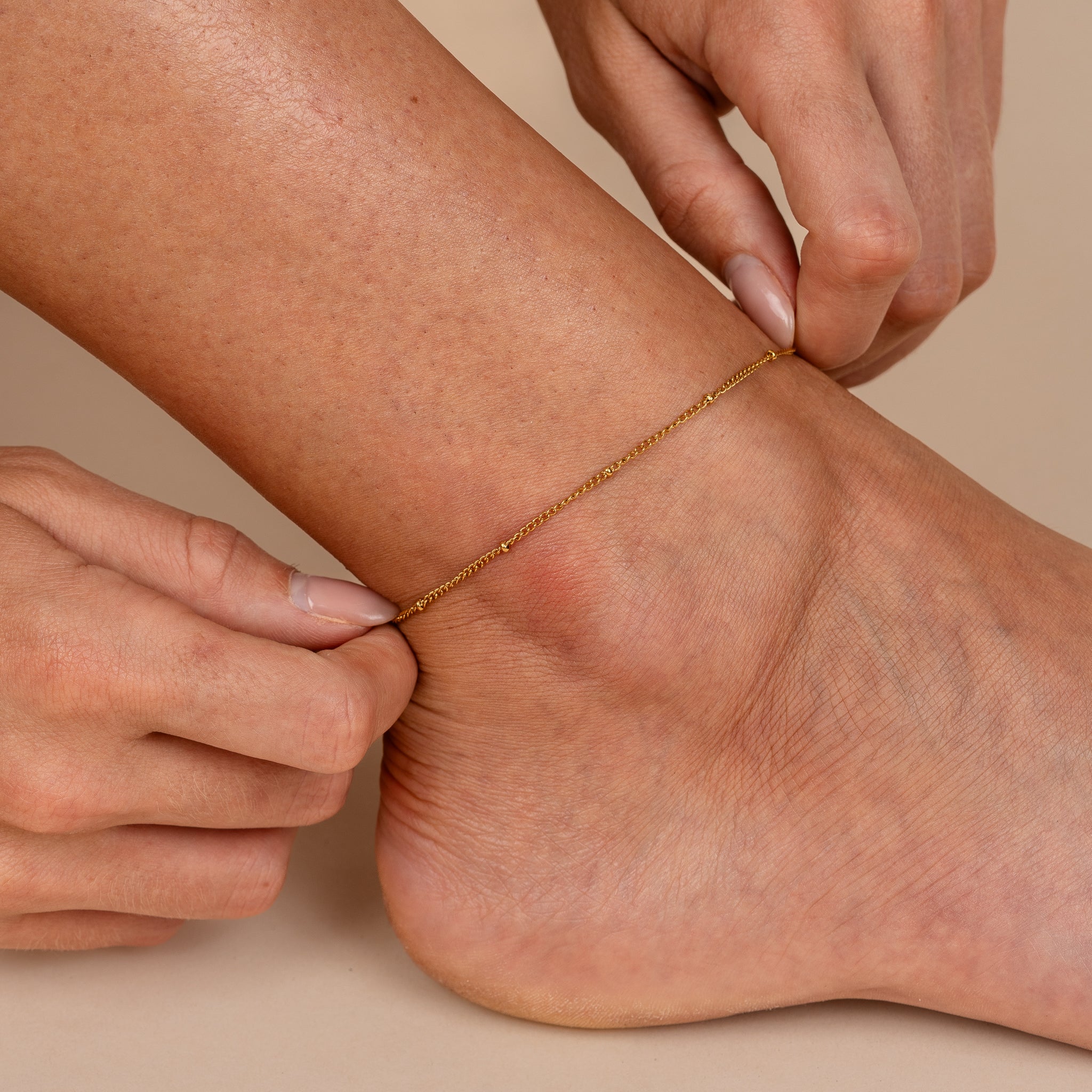 Minimalist gold fine-chain anklet on model — Raya Fine Anklet by Maevi